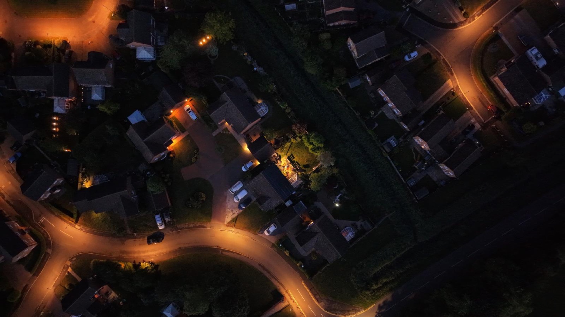 Aerial view of a Lincolnshire residential street at night with homes lit up